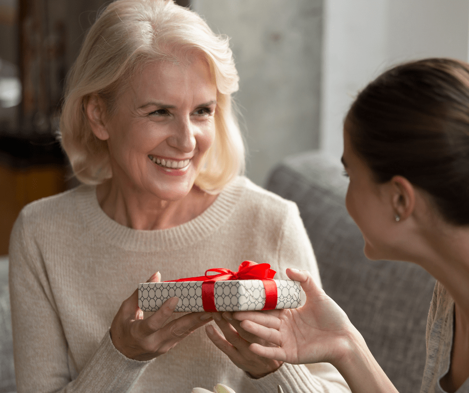 Adult daughter giving her mother a present